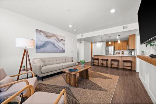 a living room with a couch and a table at Modern Downtown 2BR 2BA Near Delta Center with Fire Pit BBQ and City Views in Salt Lake City