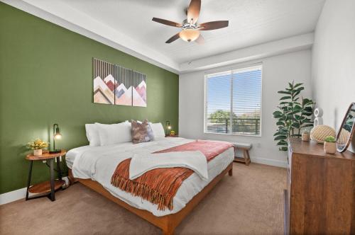 a bedroom with a large bed and a ceiling fan at Modern Downtown 2BR 2BA Near Delta Center with Fire Pit BBQ and City Views in Salt Lake City