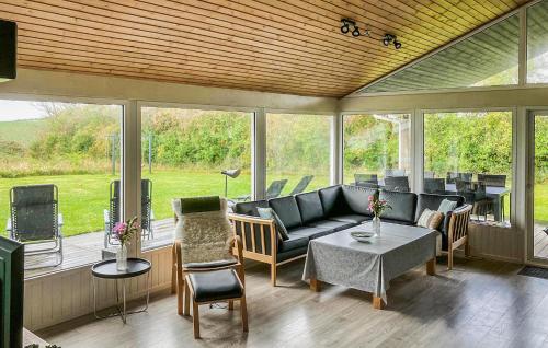een afgeschermde veranda met een bank en stoelen bij Nice Home In Sydals With Wifi in Høruphav