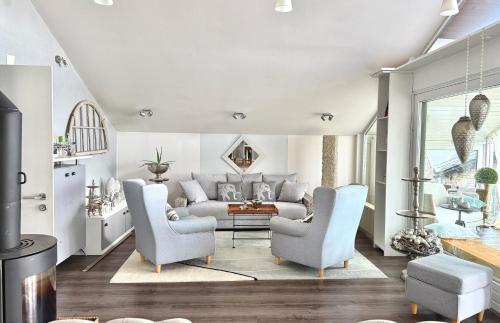 a living room with a couch and two chairs at Westerwald Hideaway 