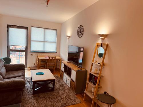 a living room with a couch and a table at Entire 1 bed flat in the heart of London Islington in London