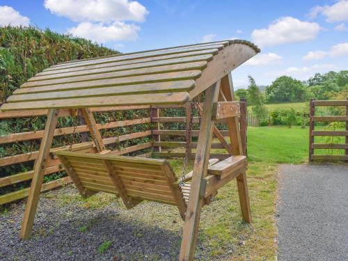a wooden gazebo with a wooden roof at Bryn Melyn - Uk6518 in Frongoch