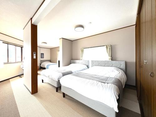 Postel nebo postele na pokoji v ubytování ango kawaguchiko1