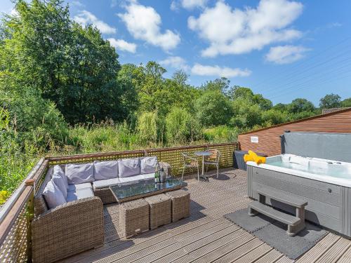 a hot tub sitting on top of a deck at Waterside Lodge Thirteen - Uk11853 in Southowram