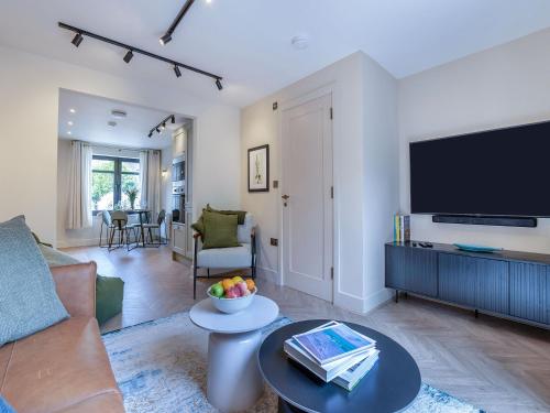 a living room with a couch and a flat screen tv at Sea Beet - Uk49245 in Whitstable