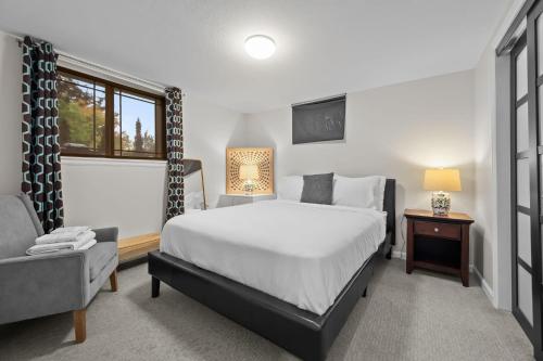 a bedroom with a bed and a chair and a window at 1815 Bluebell Ave in Boulder