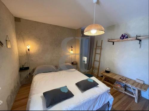 Un dormitorio con una gran cama blanca con almohadas. en Villa Férus Piscine chauffée, en Buis-les-Baronnies