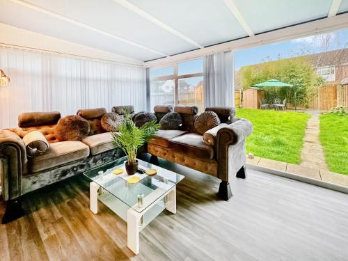 a living room with a couch and a table at Sunrise Villa in Clacton-on-Sea