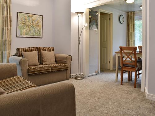 a living room with a couch and a table at The Secret Garden in Windermere