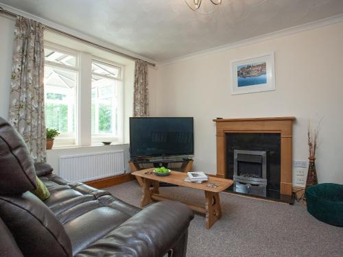 a living room with a couch and a fireplace at Tanglewood in Bugle