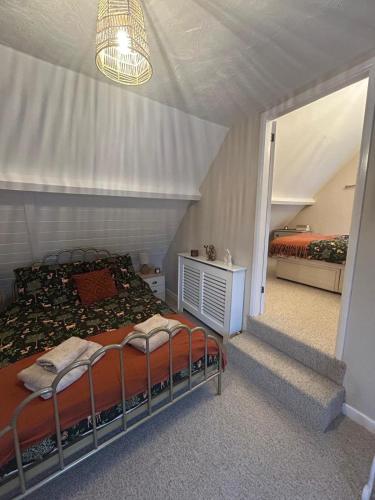 a bedroom with two beds in a room at The Snug in Goodrich