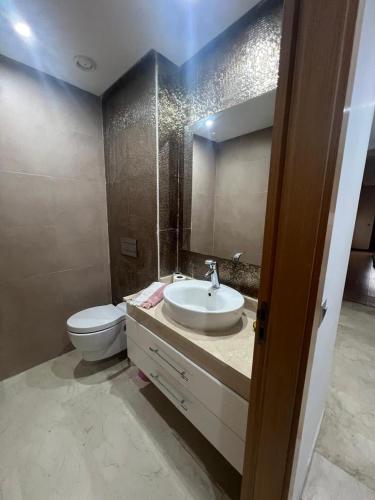 a bathroom with a sink and a toilet at Beach appartement in Kenitra