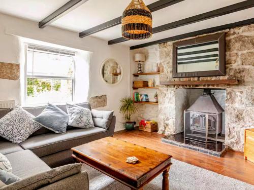 ein Wohnzimmer mit Couch und Kamin in der Unterkunft Sunnyside Cottage Retreat in Penwithick