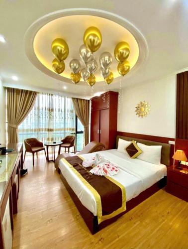 a hotel room with a bed and a fancy ceiling at Bạch Dương Hotel Hà Nội in Hanoi