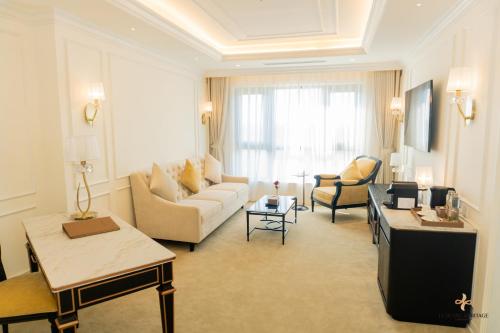 a large living room with a couch and chairs at Le Blanc Heritage Hotel in Yen Bai
