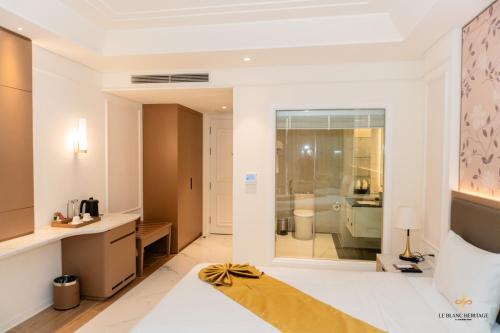 a room with a bathroom with a toilet and a sink at Le Blanc Heritage Hotel in Yen Bai