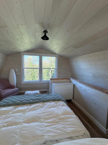 a bedroom with a bed and a window at Modern Tiny Barn Urban Oasis in San Antonio in San Antonio