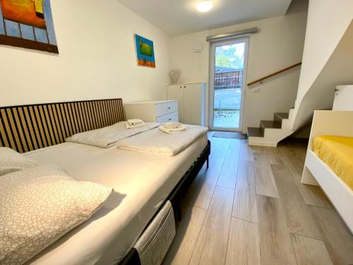 two beds in a room with a staircase at Bohinj - Old Village House in Bohinj