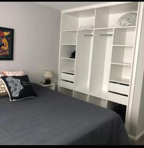 a bedroom with white shelves and a bed at Morada del Mar in Mar de Cobo