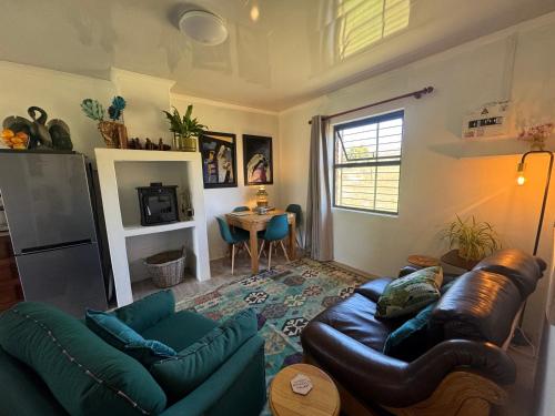 a living room with a couch and a table at Tulbagh Tiny Homes in Tulbagh