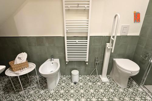 a bathroom with a toilet and a bidet at La Casetta nel Borgo in Cerisano
