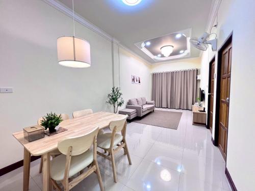 a dining room and living room with a table and chairs at I'm Home Narathiwat in Narathiwat