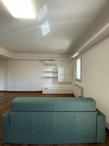 un salon avec un canapé bleu dans une pièce dans l'établissement Case Vacanze Naiade e Nereide, à Reggio de Calabre