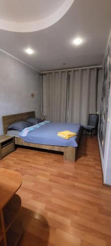 a bedroom with a bed and a wooden floor at Saules line in Daugavpils