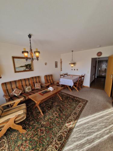 a living room with a couch and a table at Foresty Appartement in Schonach