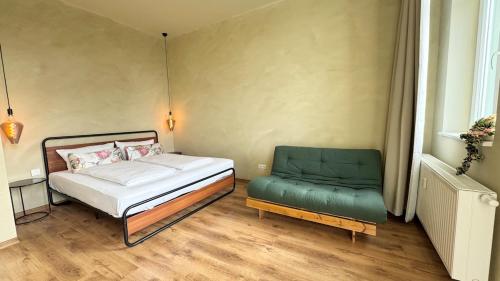a small bedroom with a bed and a chair at Nordic Zen Loft mit Garten in Magdeburg