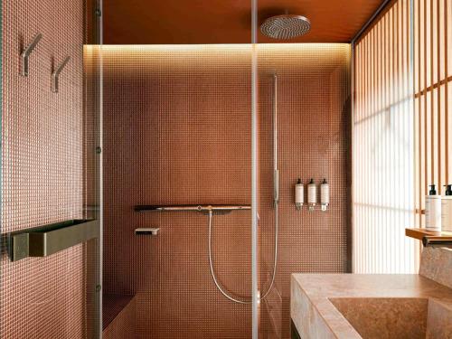 a shower with a glass door in a bathroom at SO/ Paris Hotel in Paris