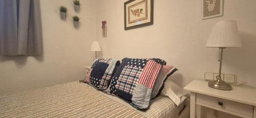 a bedroom with a bed with pillows on it at Manzaneda Natura Apartments T1 in Puebla de Trives