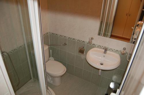 a bathroom with a sink and a toilet and a shower at Family Hotel Dayana Beach in Sinemorets