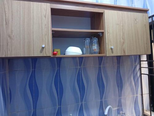 een kast met blauwe gordijnen in een keuken bij Entire 1 Bedroom flat in Lagos in Orile