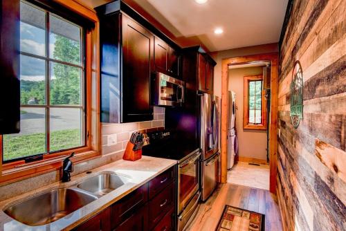 a kitchen with a sink and a refrigerator at Banner View in Banner Elk