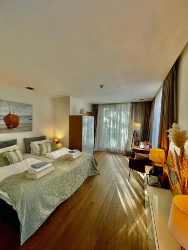 a large bedroom with two beds and a desk at SURF HOUSE DREAMERS COAST in Klaipėda