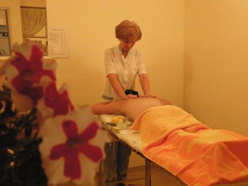 a woman in a hospital room with a patient on a bed at Family Hotel Dayana Beach in Sinemorets