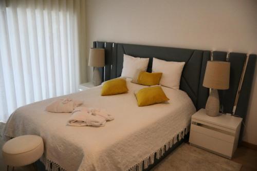 a bedroom with a large bed with towels on it at Sonho Verde in Ribeira de Pena