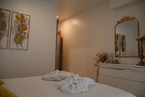 a bedroom with a bed with a towel on it at Sonho Verde in Ribeira de Pena