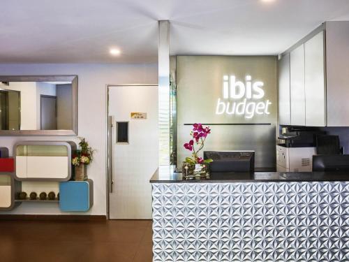 a kitchen with a sign that reads kids burger at ibis budget Singapore Mount Faber in Singapore