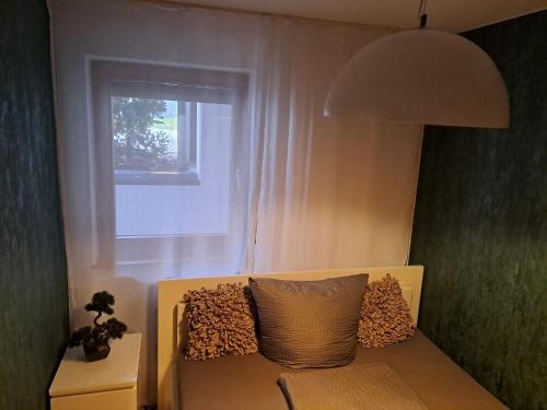 a couch sitting in a room with a window at Viktor Apartment in Titisee-Neustadt