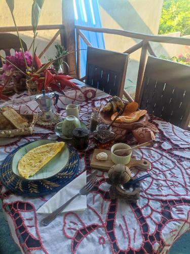 a table with a plate of food on it at La Maison de Morgana in Ambaro