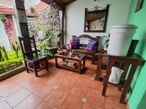 a living room with chairs and a table and a couch at Hotel Casa Nikté in Antigua Guatemala