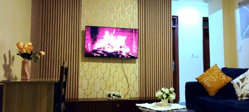 a living room with a tv hanging on a wall at GoldenSpark Homes in Thika