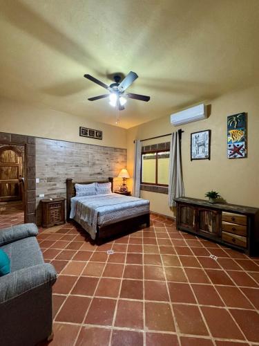 a bedroom with a bed and a ceiling fan at Calendario Vacio in Loreto