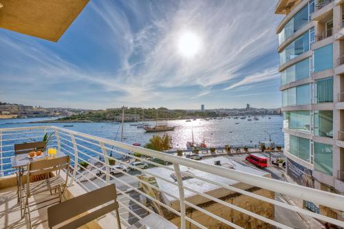 a balcony with a view of a body of water at Stunning Seafront Apartment with Panoramic Views in Sliema