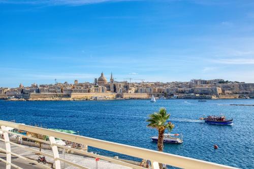 a view of a body of water with boats at Stunning Seafront Apartment with Panoramic Views in Sliema