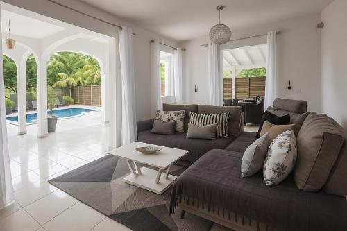 a living room with a couch and a table at Villa Lawrencia in Morne-à-lʼEau