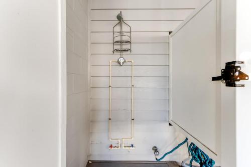 a shower in a bathroom with white walls at Seabreeze village 3 in Dewey Beach
