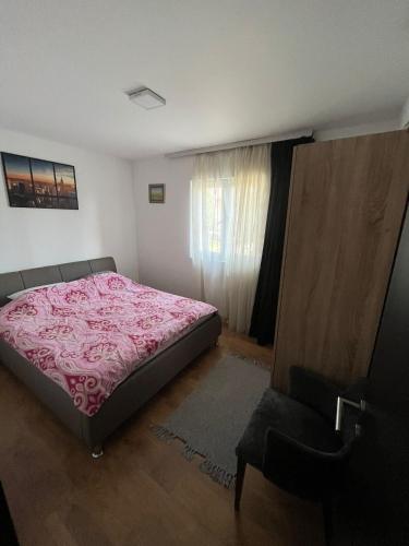 a bedroom with a bed with a pink blanket at 2BR Apartment Gaga near Airport W Free Private Parking in Surčin
